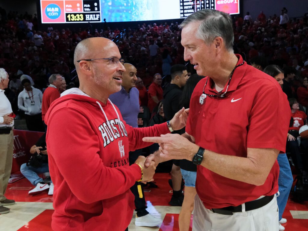 Astros Manager Joe Espada and UH football coach Willie Fritz enjoyed a moment, two coaches talking ball. (Photo by F. Carter Smith)