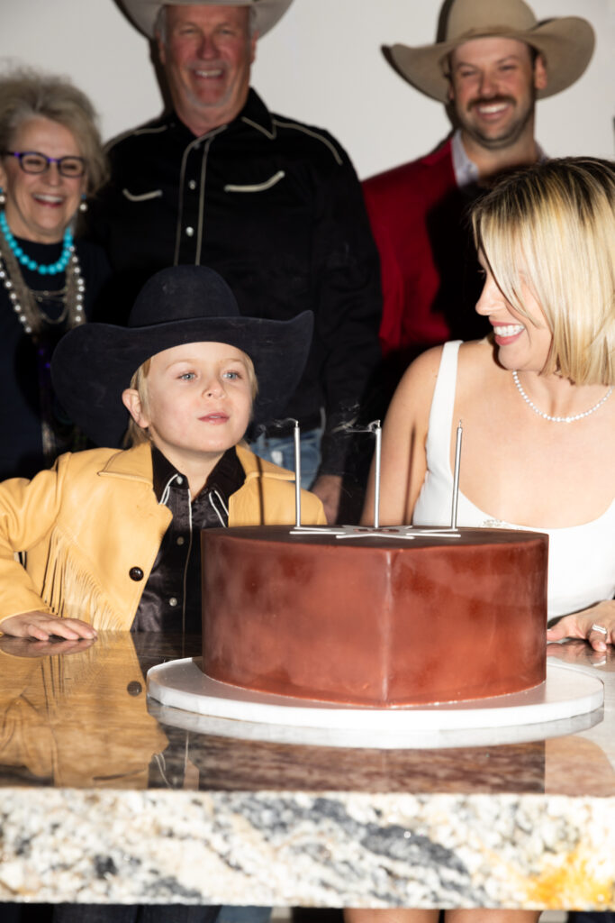 To celebrate 10 years of CITY Boots, owner Lizzy Bentley blew out candles as attendees sang "Happy Birthday." (Photo by Photographs by Kaitlin Saragusa)