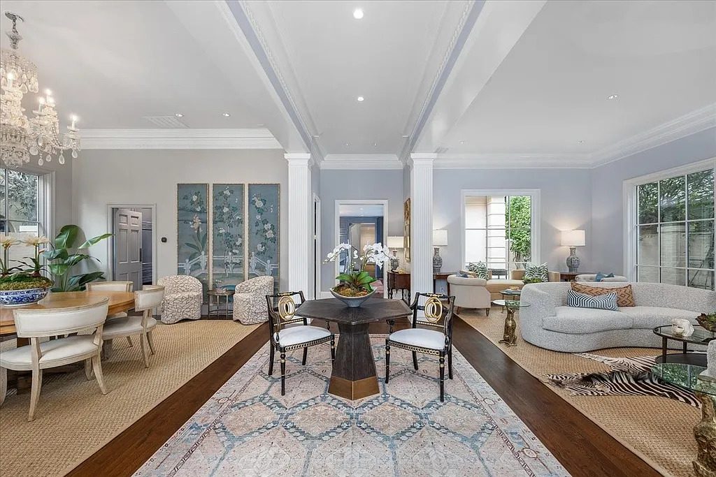 Twelve-foot ceilings, bold crown molding, and elegant columns frame the main living space. (Courtesy)