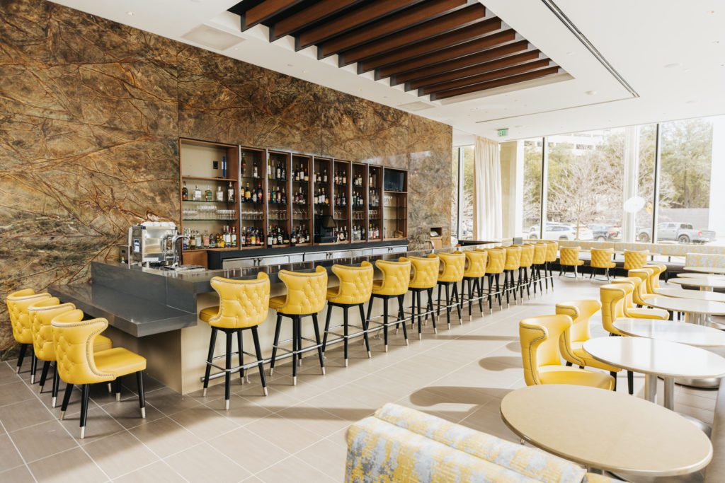 The dramatic yet sunny bar at 61 Osteria, backed by book matched Indian marble. (Photo by Kathy Tran)