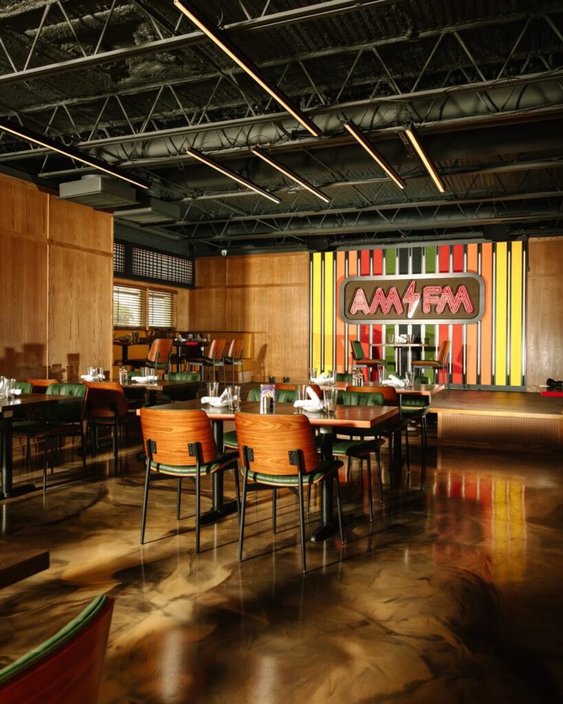 The former barbecue spot underwent a renovation and now features a revamped interior space with a new bar, banquettes that wrap around the room, and intimate corners designed for conversation. (Courtesy of AM/FM)