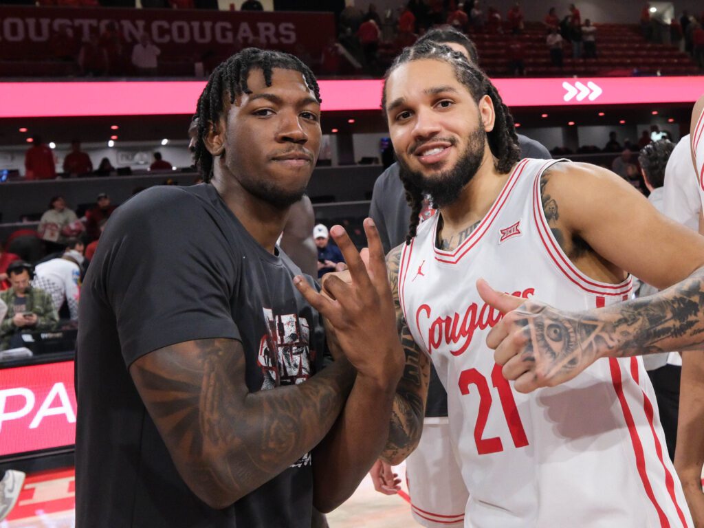 University of Houston senior guard Emanuel Sharp (right) gives the injured Kordel Jefferson some love. (Photo by F. Carter Smith)