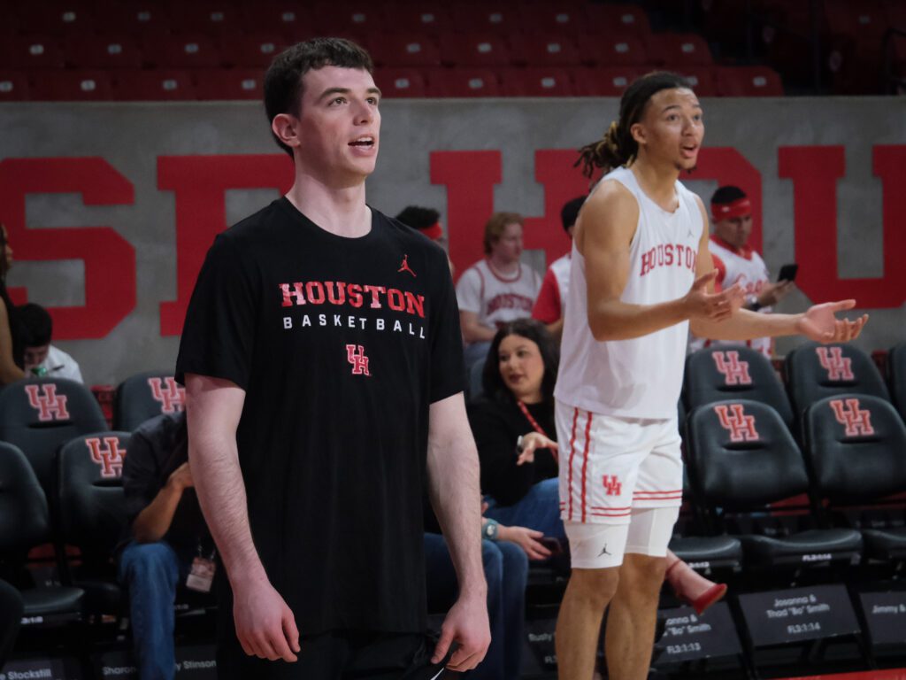 University of Houston grad assistant Ryan Elvin helps point guard Kingston Flemings work on his game. (Photo by F. Carter Smith)