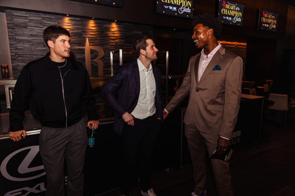 Rockets guard Reed Sheppard, Patrick Fertitta and Rockets forward Jae’Sean Tate take in the 'Heart of a Champion' gala.