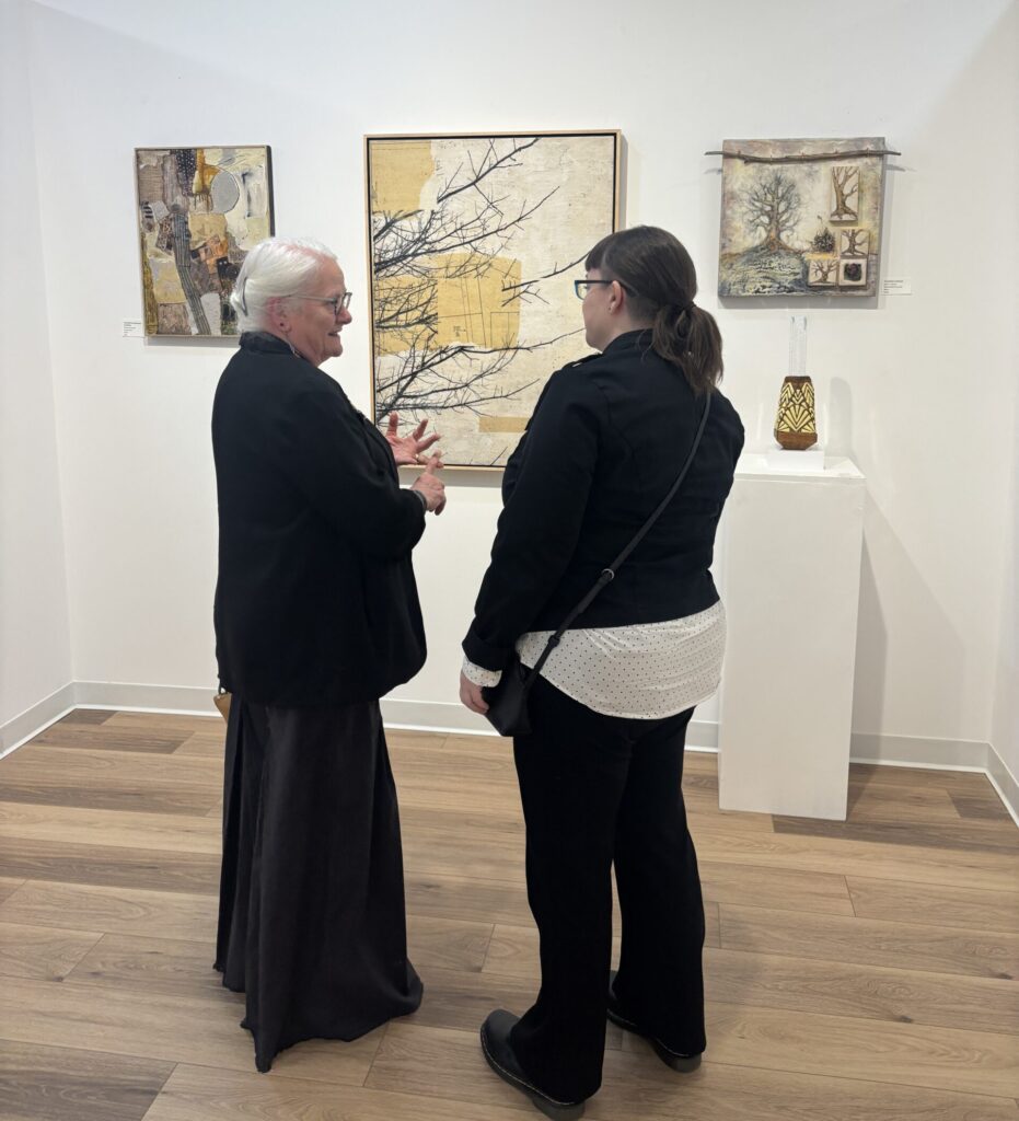 Artists Janet Haynes (left) and Shauna Martin discuss Martin’s “The Mending Project” at the opening reception for “Material Matters” at Ardest Gallery. (Photo by Laura Landsbaum)