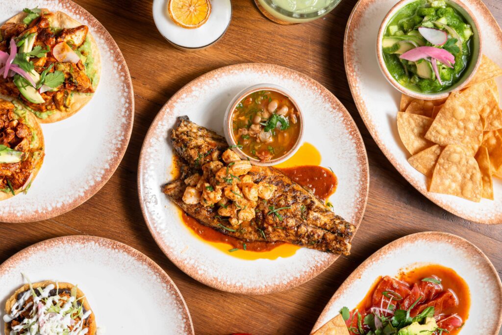 Featured center: The signature spiced-rubbed snapper a la parilla ($32), grilled over charcoal and finished with garlic butter, jumbo lump crabmeat, and mole Amarillo. (Photo by Photos by Hasan Yousef)