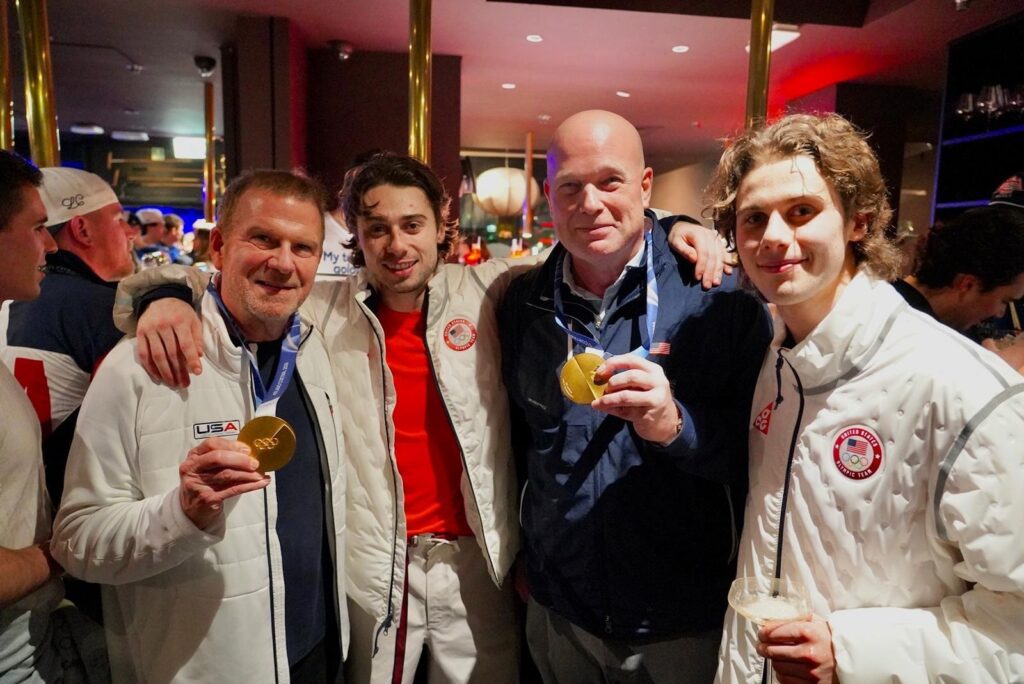Ambassador Tilman Fertitta, hockey standout Quinn Hughes, US Ambassador to NATO Matthew Whitaker and overtime hero Jack Hughes celebrate the US Olympic hockey team's gold medal at the Winter Olympics. (Courtesy photo)