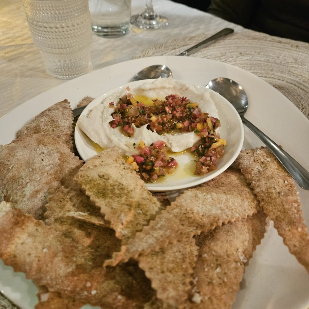 The bread service — baked lavash served with whipped lardo and a finely chopped garnish — was delicious and unfussy.  (Courtesy)