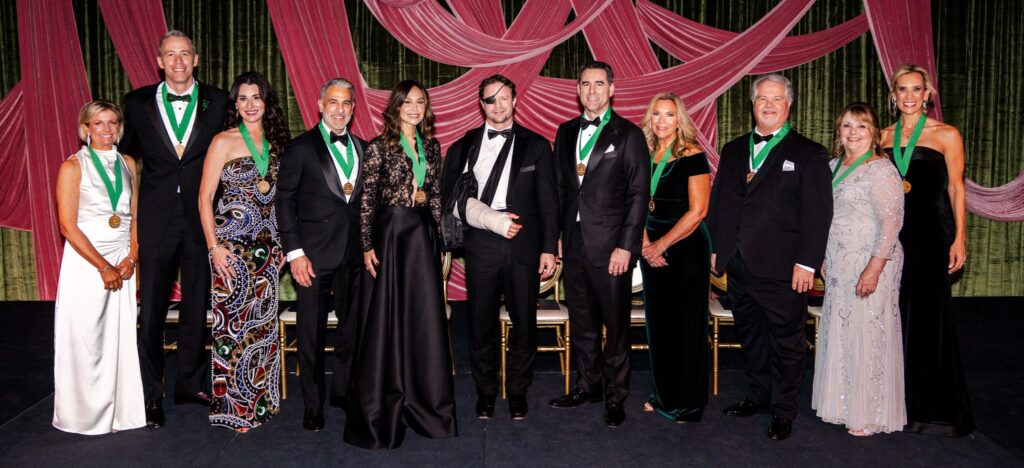 Linda Nelson (far left), Congressman Dan Crenshaw (center) and CEO Missy Herndon (far right) with the 2026 Hometown Heroes inductees Jim Carman, Michelle Little, Lonny Soza, Elvira Graham, David Bernard representing Houston Methodist The Woodlands Hospital, Ann Wolford representing In the Pink of Health, John Powers and Laran Cone. (Photo by Interfaith of The Woodlands)