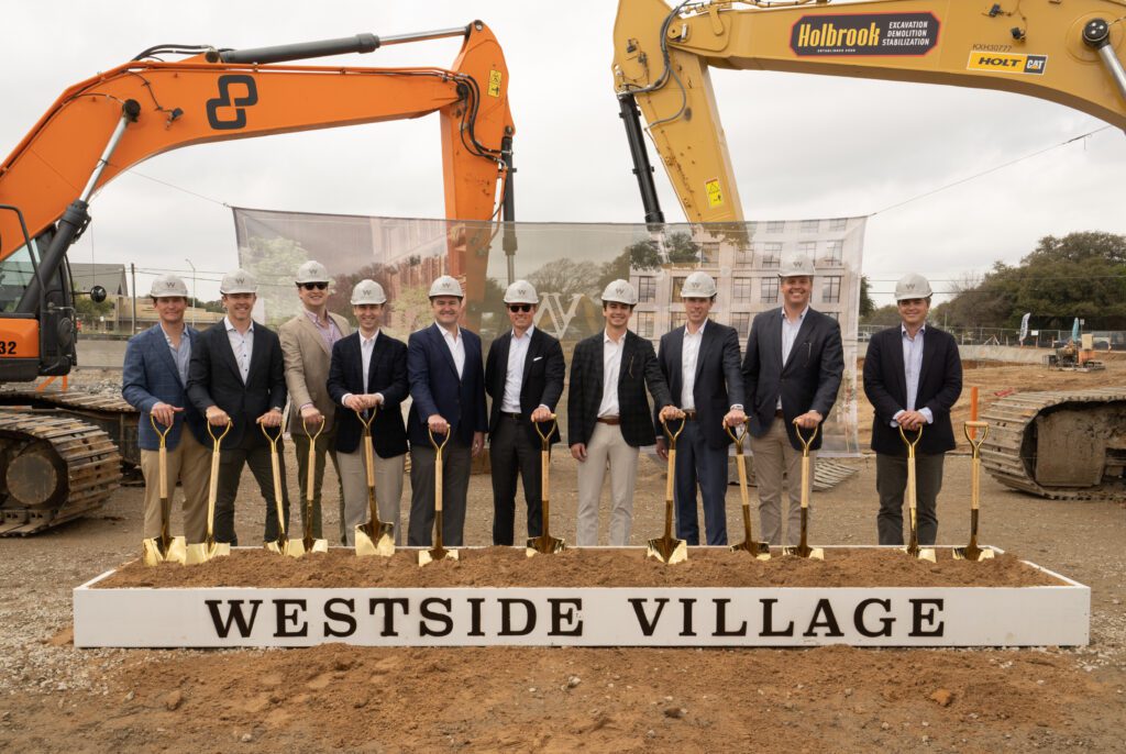 Developers and partners tied to the Westside Village project gather before a large excavation site. (Photo courtesy of Brynn Bagot Public Relations)