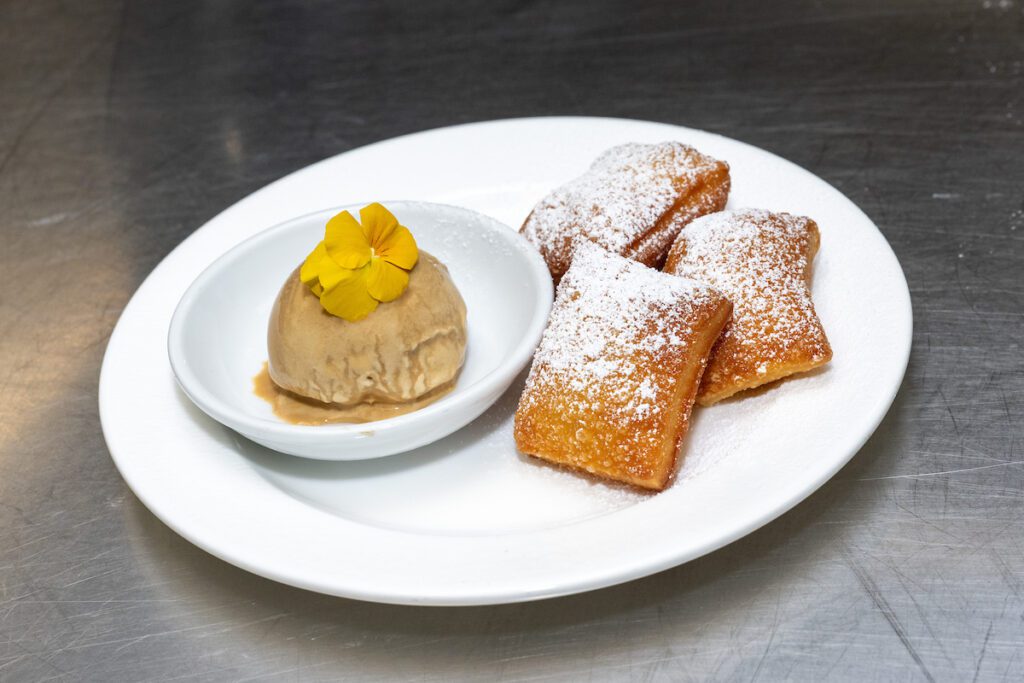 Beignets with chicory coffee ice cream and brandy milk punch served at the 'Tribute to Louisiana Legends' dinner held at The Manor House at The Houstonian  (Photo by Jacob Power)