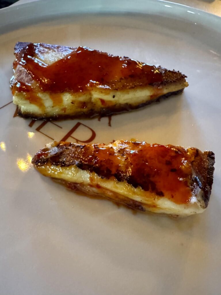 Our first dish was the saganaki, a dense, slightly salty hard cheese served with chile honey. (Photo by Walt Burns)
