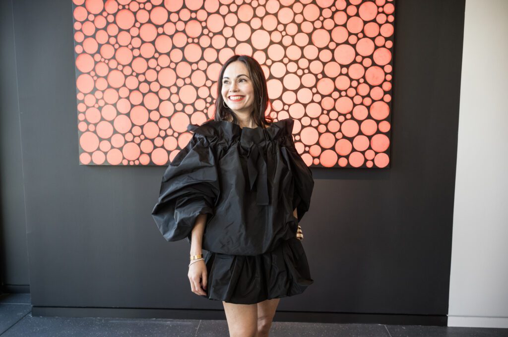 Michele Leal Farah in front of 'Dots Obsession' by Yayoi Kusama at the Opera Gallery VIP opening (Photo by Daniel Ortiz)