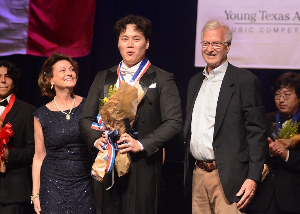 Annette and Ken Hallock of The Woodlands present baritone Heechang Byun with the Young Texas Artists Audience Choice Award. Byun also won the gold medal in the Voice division. (Photo courtesy of David Hopper)