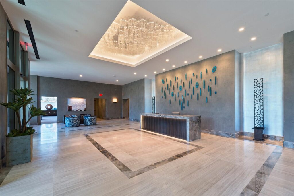 A grand, contemporary lobby welcomes residents and guests with refined finishes, bespoke lighting, and full-service concierge.