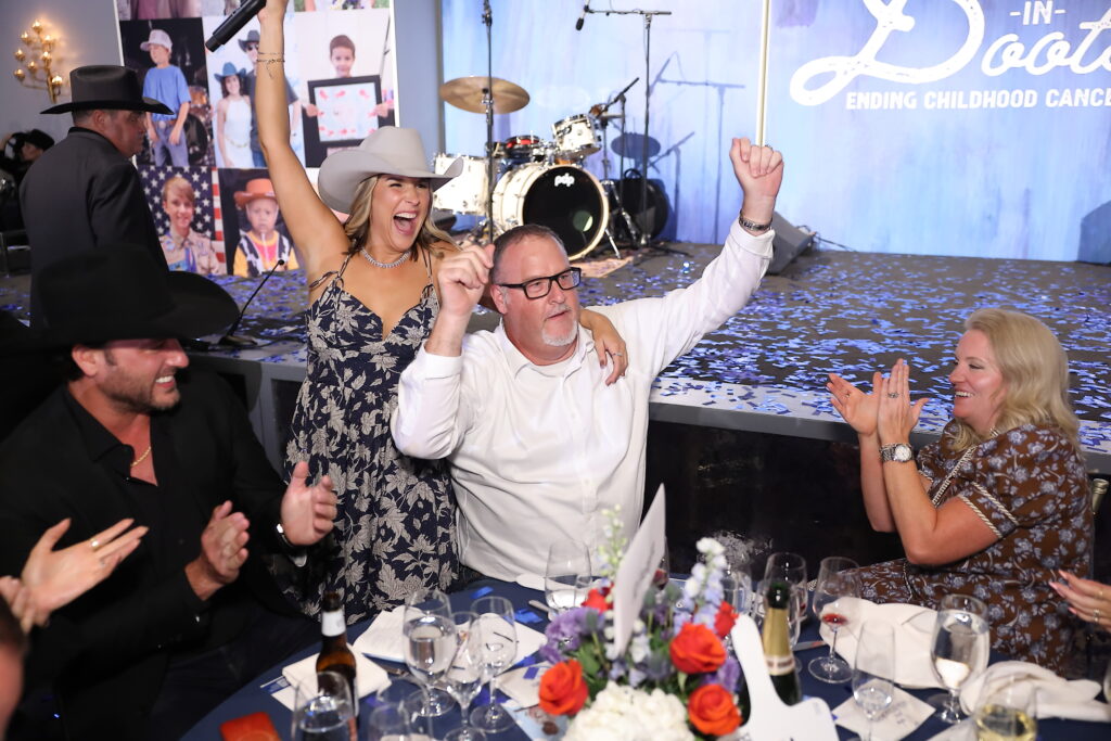 Brittany Franklin and Strider Noone, Senior Sales Manager with JD Fields & Company, wins the Villa in Cabo donated by Matt Hubbard for $175,000 on behalf of JD Fields & Company (Photo by Quy Tran) Photography