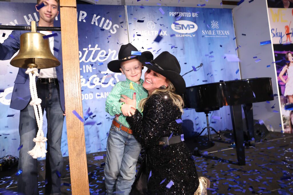 Cancer Warrior Ledger Robertson and his mother Haley Robertson at the Sky High for Kids 'Boots are Better' gala (Photo by Quy Tran Photography)