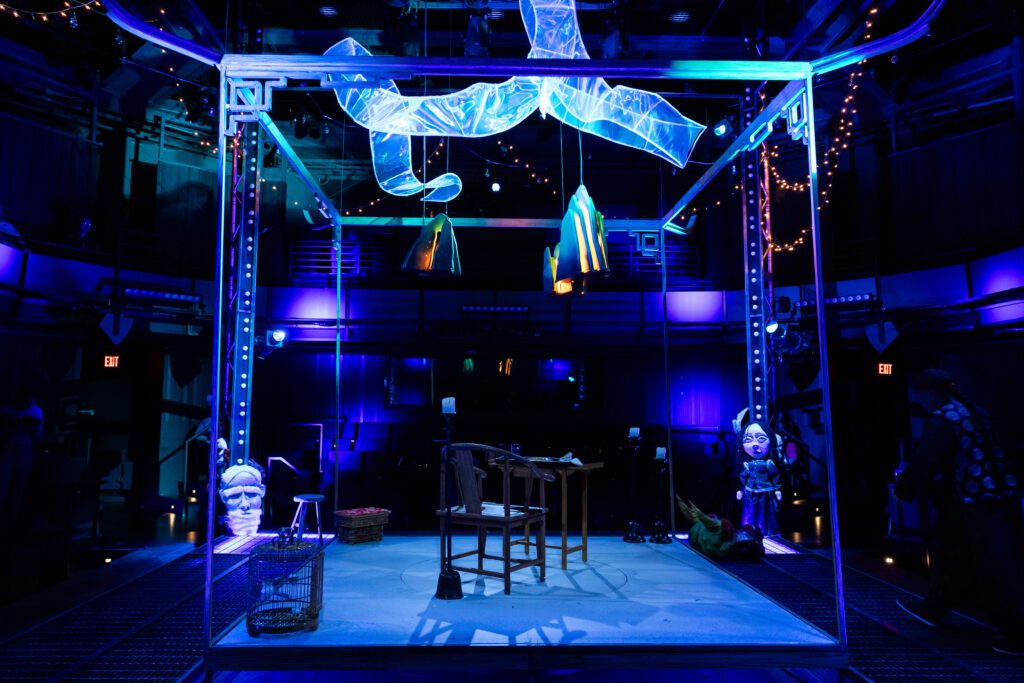 The spare set frames Afong Moy like a living exhibit in Stages’ “The Chinese Lady.” (Photo by Melissa Taylor)