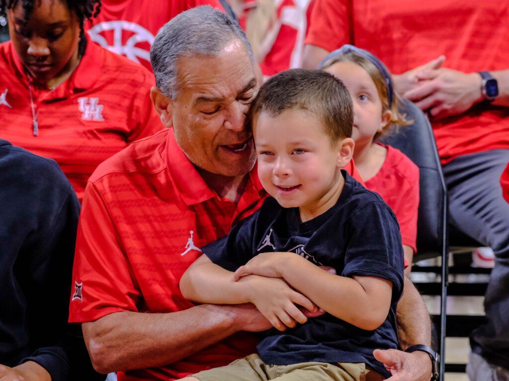 University of Houston coach Kelvin Sampson keeps his grandson Kylen close during Selection Sunday. (Photo by F. Carter Smith)