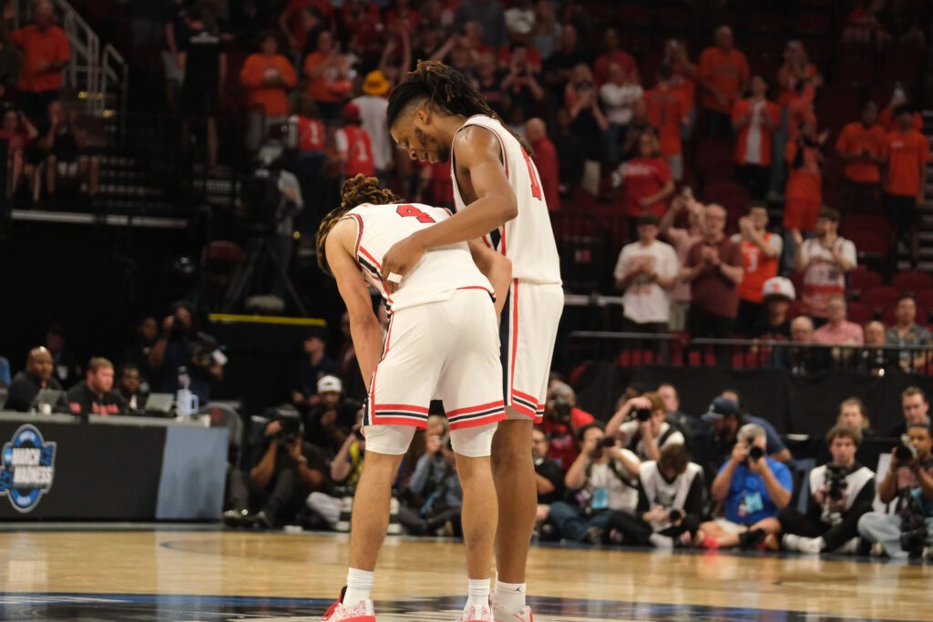 Houston freshman point guard Kingston Flemings almost couldn't bare to stand after the final buzzer of this Sweet 16 loss. JoJo Tugler went over to get him. (Photo by F. Carter Smith)