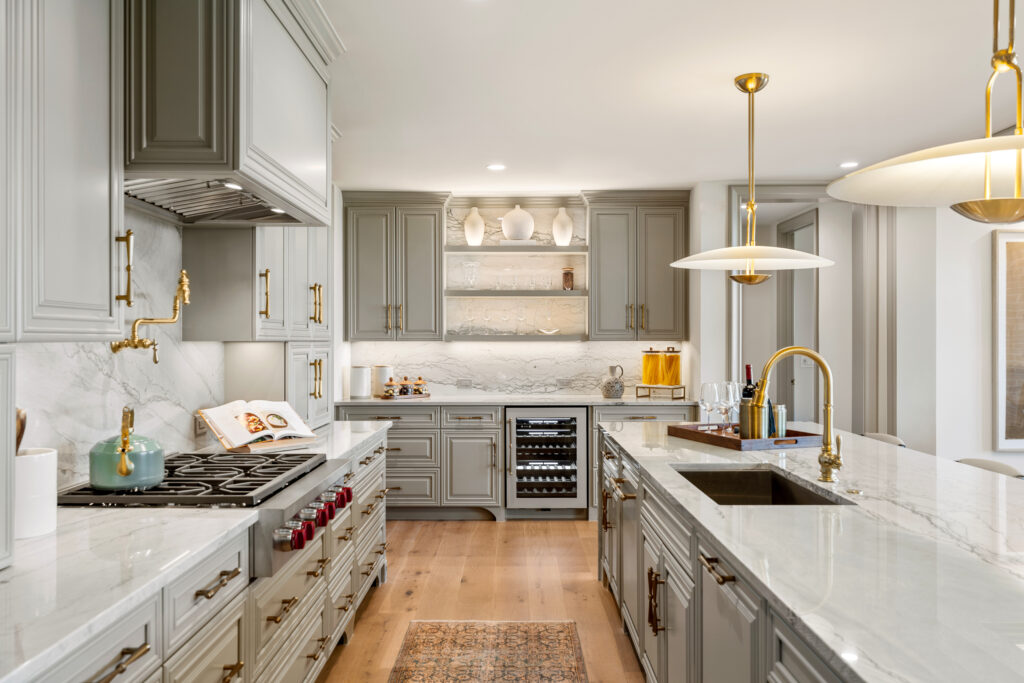The kitchen features quartzite countertops, custom cabinetry and decorative brass hardware. (Photo by Josh Gremillion with Gremillion Media) 