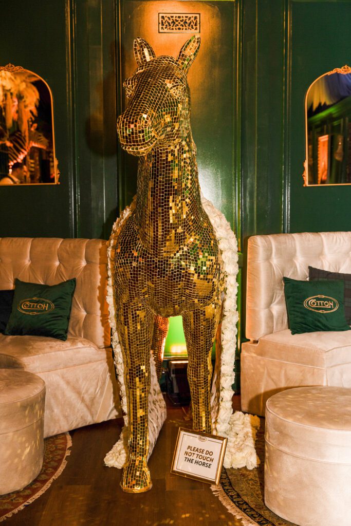 The golden pony draped in a blanket of white roses in the Gold Pony liar at the Cotton Q club (Photo by Kaitlin Saragusa)
