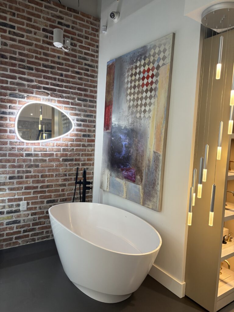 Freestanding tubs are on display in the showroom, as is a unique air vent drying system for glass shower doors.