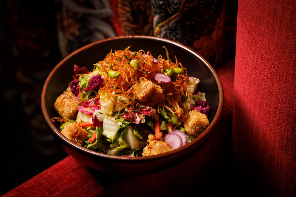For the Rooster Salad, fried chicken nuggets top a hefty portion of greens with a tasty ginger sesame vinaigrette. (Photo by Samantha Marie Photography)
