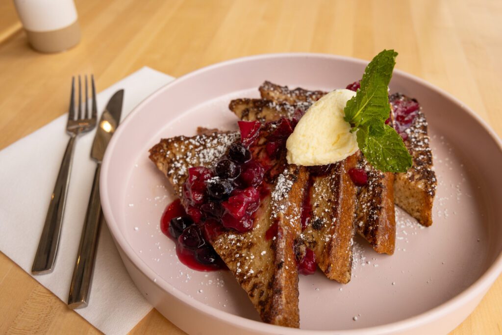 The Milk Bread French Toast, topped with a berry compote and sweet mascarpone, is a must-try at Cafe Olivia. (Courtesy)
