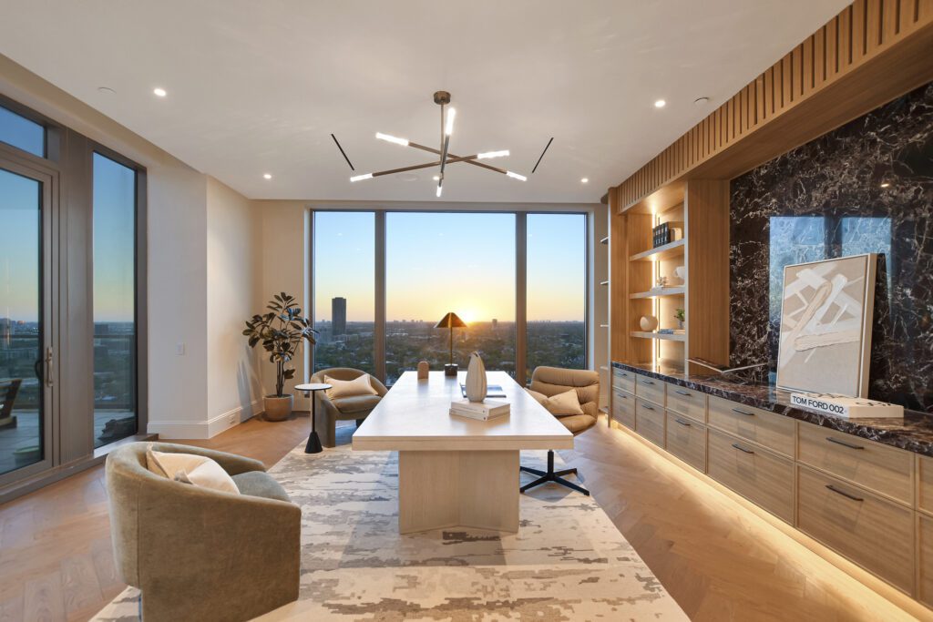 A serene living space with floor-to-ceiling windows capturing breathtaking sunset views over Houston.