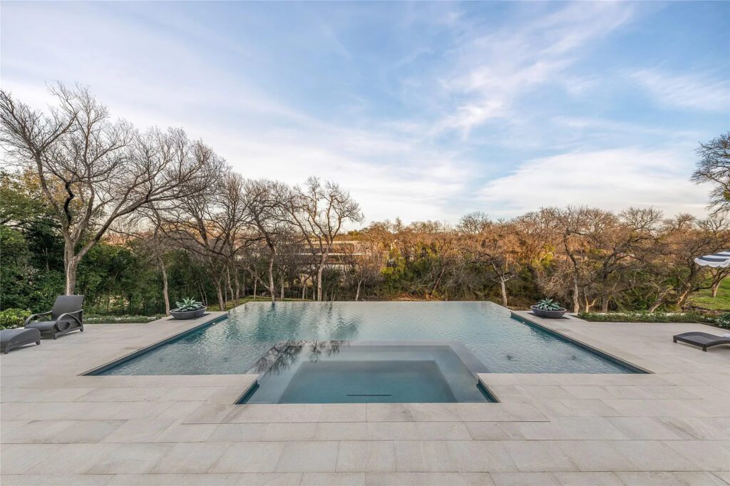 10010 Strait Lane features a negative-edge pool, spa, sun deck, and fire pit. (Photo by Allie Beth Allman & Associates)