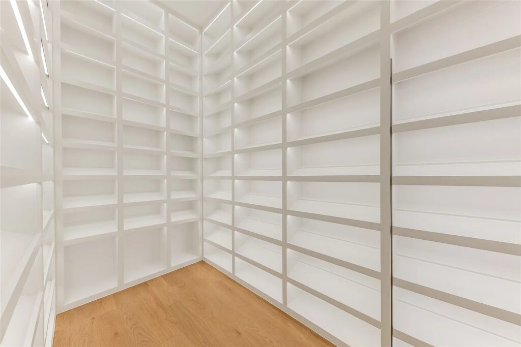 The lady of the house's closet has an island, along with a Carrie Bradshaw dream shoe closet, as well as hidden handbag and jewelry closets. (Photo by Allie Beth Allman & Associates)