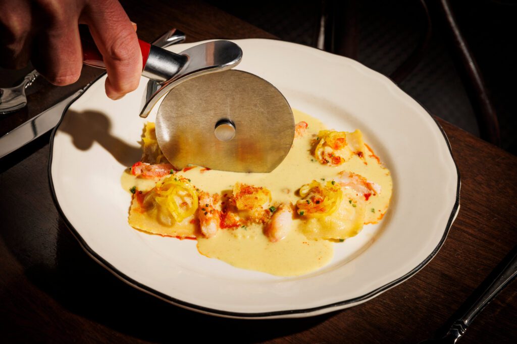 The Snow Crab 6 Pack at The Charles is a ravioli cut tableside. (Photo by Samantha Marie Photography)