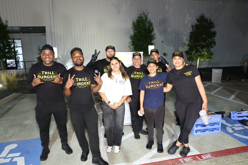 The Trill Burger Team delivering end of night burgers for the departing crowd at the Sky High for Kids 'Boots are Better' gala (Photo by Quy Tran Photography)