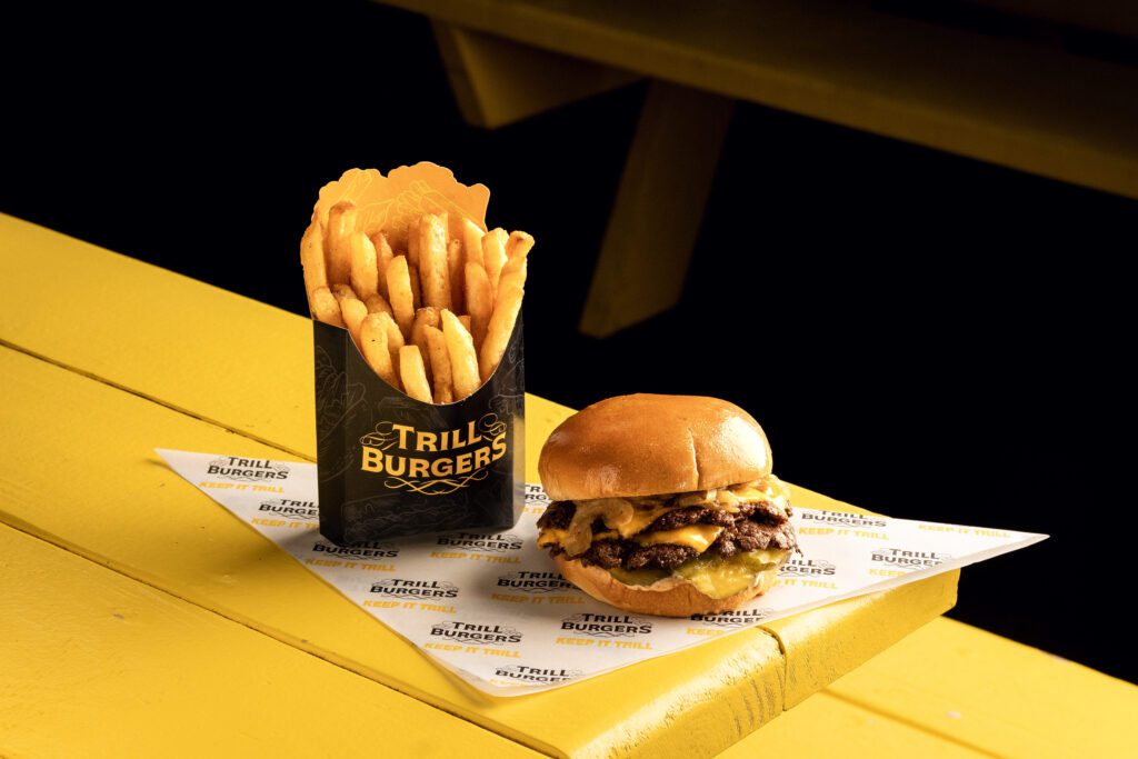 Trill Burgers' smashburger, made with all-beef patties, caramelized onion, pickles, and their patented Trill Sauce, developed from a shared “obsession” with burgers. (Courtesy)