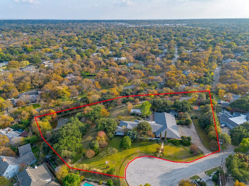 An aerial view reveals the full 4.26-acre estate at 4301 Briarhaven Road, with the home set deep within a sweeping expanse of lawns, trees, and water features in the heart of Overton Park. (Courtesy)