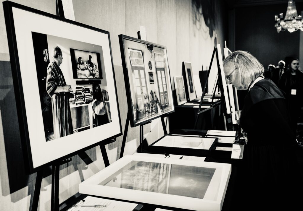 A guest peruses photography at the 2026 FotoFest Biennial Gala and Fine Print Auction. (Photo by Johnny Than)