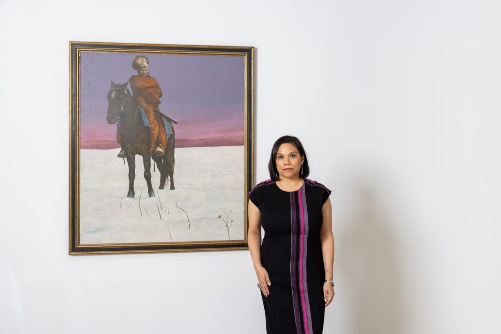 Hooks-Epstein Galleries’ Yvonne Garcia with Kermit Oliver’s "Untitled (Indian on Horseback)," circa 1970s. (Photo by Alex Barber)