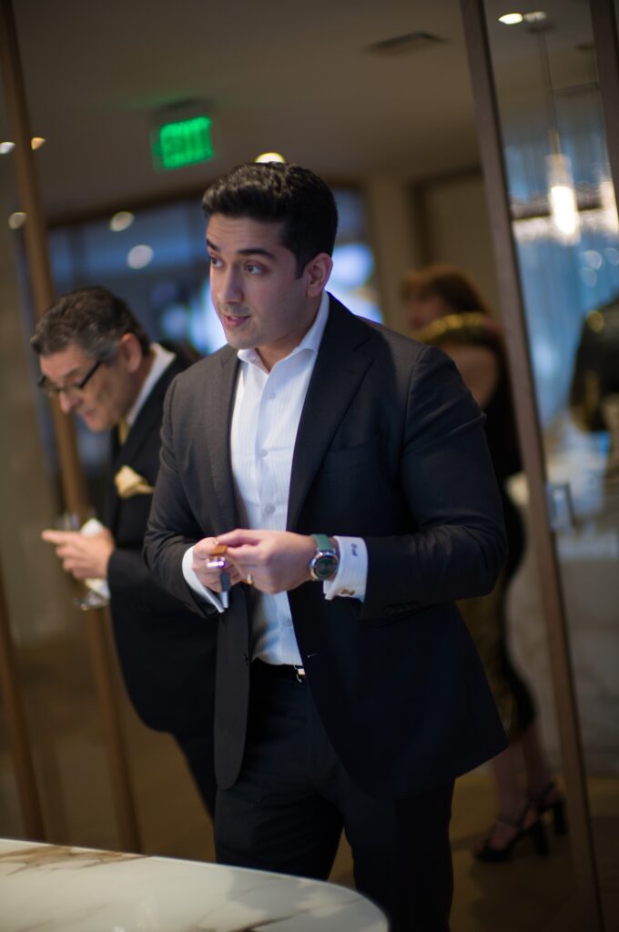 A guest is intrigued by watches on view  at the St. Regis Residences Houston/Phillips cocktail party (Photo by Daniel Ortiz)