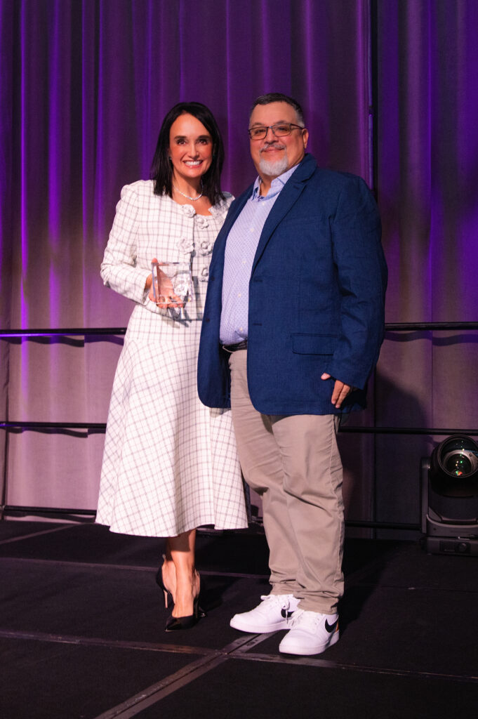 CPD president and CEO Joanna Clarke presenting Paige McDaniel Partners for Children Award to AWS representative Alberto Bayarena (Photo by Tamytha Cameron, Celeste Cass, Nate Rehlander and Kelly Alexander)