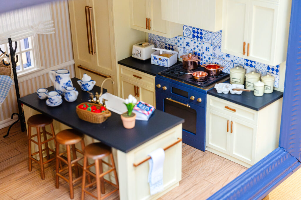 "The Sunny Stripe Kitchen" by Noel Pittman Design utilizes Edwin Stripe wallpaper by Schumacher, wrapping the room. (Photo by Caroline Guinn Photography)