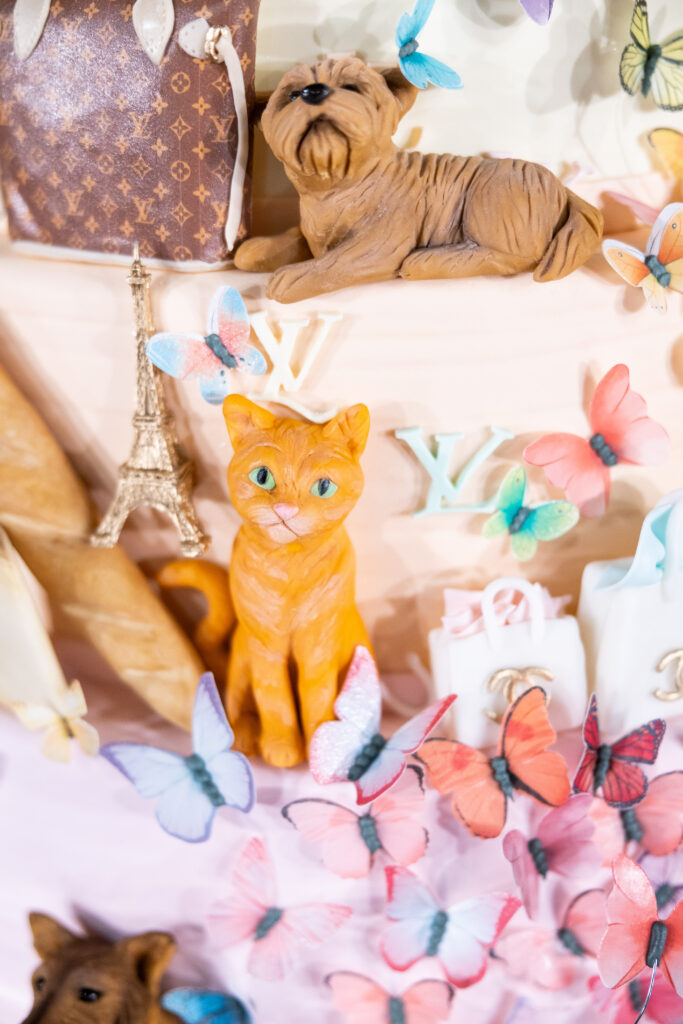 Inside the tent, magnificent cherry blossoms enveloped the entry, where a towering birthday cake that featured Beth's favorite things (in fondant) took center stage. (Photo by Anastasiia Photography)