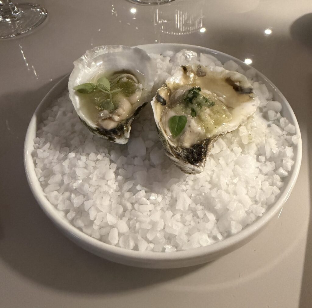 A pair of oysters, one with Indian flavors and one with Japanese flavors, were served as the first of 10 courses at the dinner. (Photo by Laura Landsbaum)