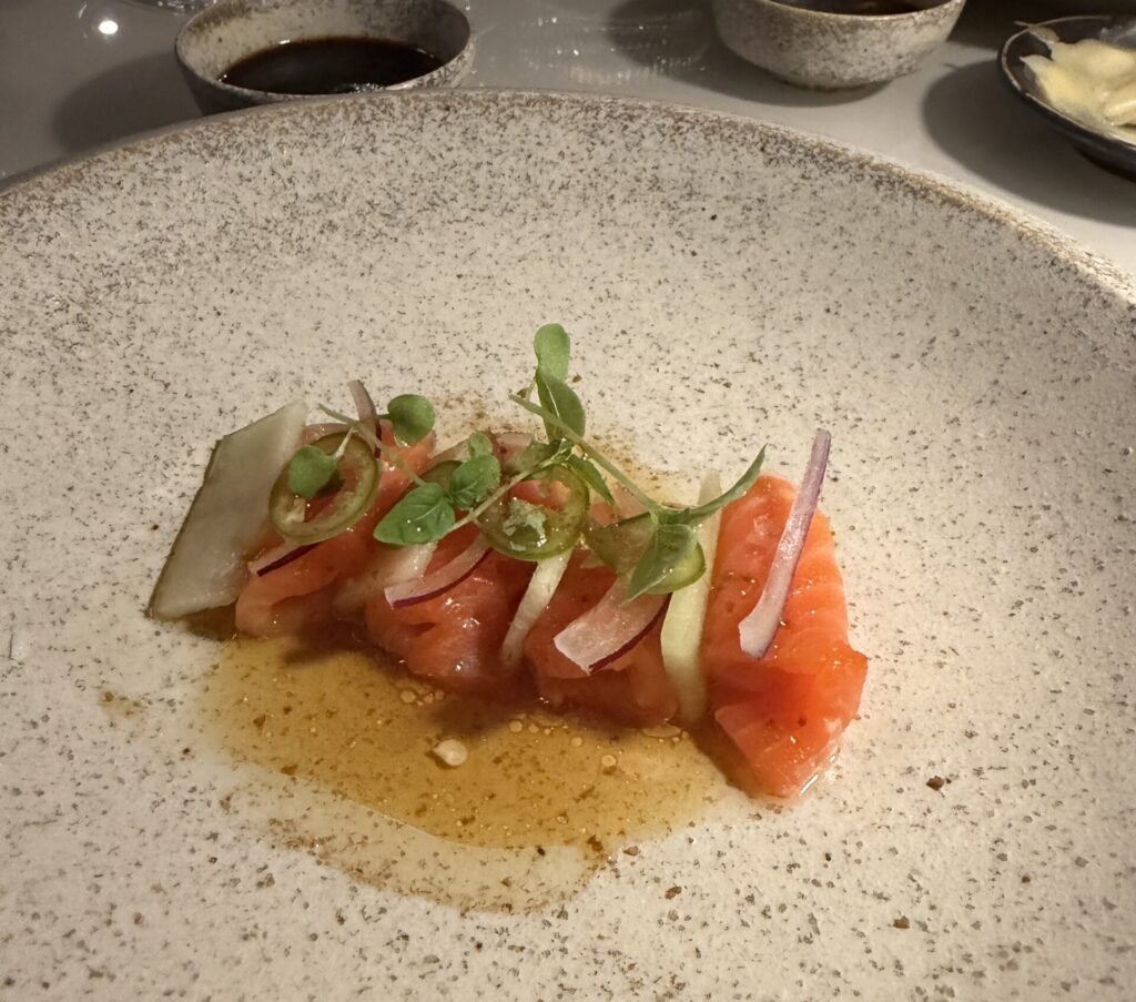 Akami crudo is served with tamarind rasam and cucumber in herb oil. (Photo by Laura Landsbaum)