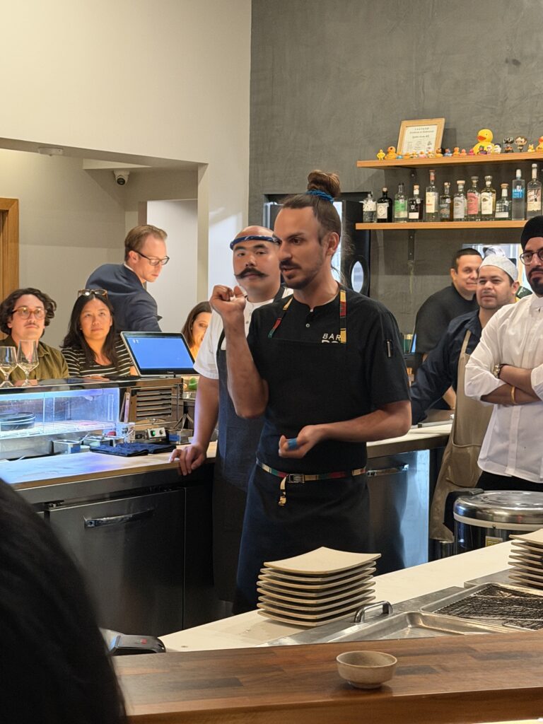 Kokoro pastry chef Zach Sendukas shares details about dessert during the collaboration dinner. (Photo by Laura Landsbaum)