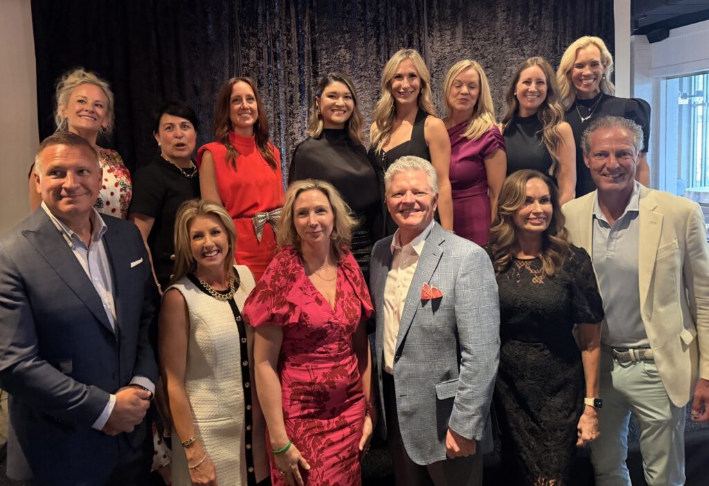 Interfaith’s 2026 The Walk Community Champions gather at the kick-off event ahead of the annual gala. Front row: Ryan and Linsey Bibler, Jo Anne and Troy Johnson, Cindy and Craig Heiser. Back row: Carrie Greenberg, Interfaith’s Julie Mayrant, Kristen Byrnes, co-chairs Tina Kosh Goodson and Kim Bonilla, Jill Simms, Sondra Lagasse and Interfaith’s Missy Herndon. (Photo by Laura Landsbaum)