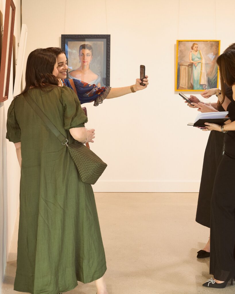 A selfie with the portraits (Photo by Heather Halbert)