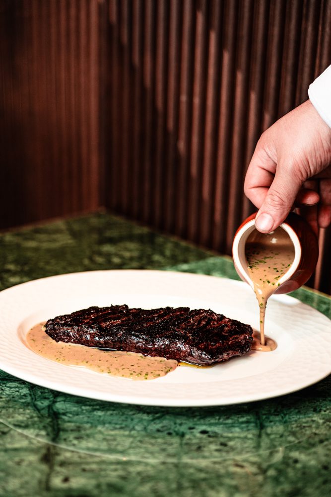 The bistecca al pepe nero, an 8-ounce koji-cured hanger steak au poivre with polenta fritta ($52) is part of Osteria di Mercato's menu.