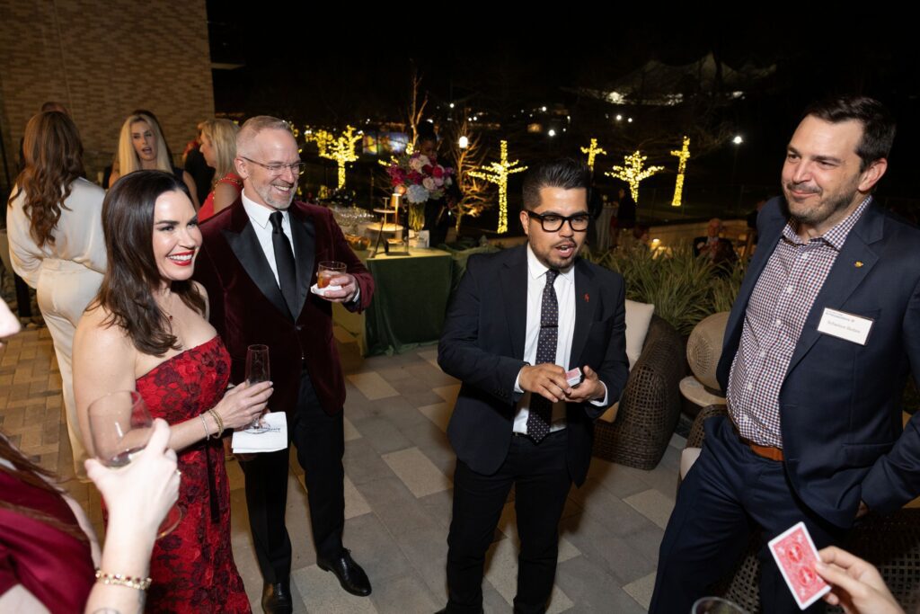 Guests enjoyed the magician at the TCH Ambassadors event at 1 Riva Row. (Photo by Jenny Antill )