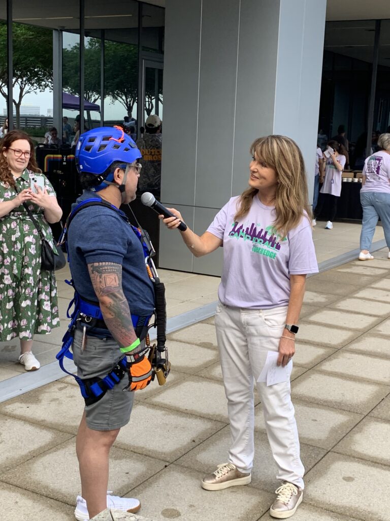 Camp For All fundraiser Sergio Campa talks with host Melissa Wilson about his experience going over the edge. (Photo by Si Vo Photography)